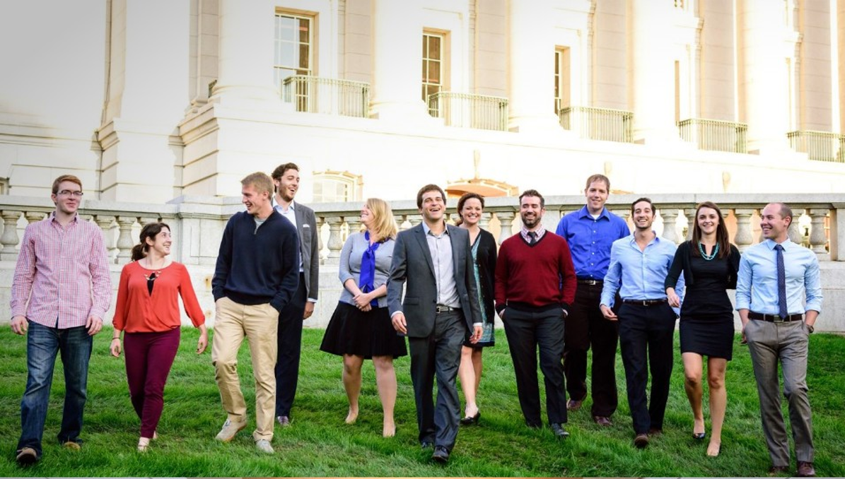 Company teammates walking together on a lawn